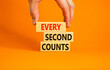 © Dzmitry - Every second counts symbol. Concept words Every second counts on wooden blocks on a beautiful orange table orange background. Businessman hand. Business, motivational and every second counts concept.