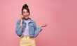 Happy young Asian teen woman talking mobile phone isolated on studio pink background.