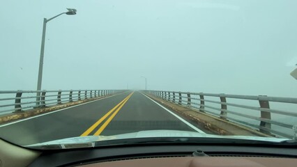 driving over the robert moses bridge heading to the fire island beaches on a foggy afternoon.
