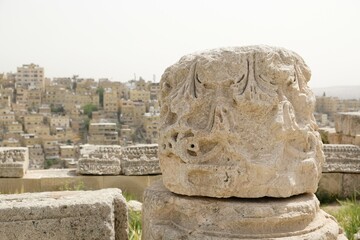 Details of ruins of Temple of Hercules in Citadel Jebel Al Qala'a in Amman, Jordan. Panorama of city in background.