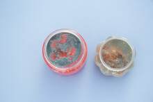 Two Jars Of Slime On Which Mold Appeared