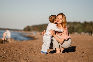 cute caucasian boy and happy mother together at coast