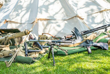  A Collection Of Sten Machine Guns Used In World War 2 Heaped Up Outside A Tent