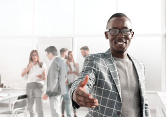 Wall Mural - young businessman reaching out for a handshake