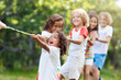 © famveldman - Kids play tug of war. Children pull rope.