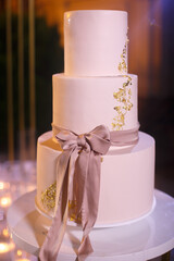 Wall Mural - Multilevel wedding cake tied with a pink bow