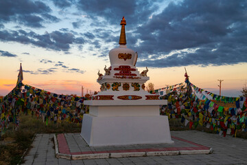 Wall Mural - Buddhist sacred stupa of Syakyusn-sume temple against the backdrop of September sunset. Elista 