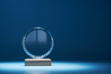 Wall Mural - crystal trophy against blue background with copy space