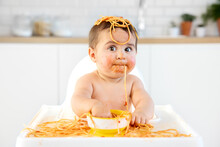 Funny Baby With Spaghetti Hanging From Mouth