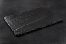 Rectangular Black Cheese Board On A Dark Background