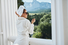 Stylish Woman In A White Robe On The Balcony Bit On Green Nature Mountain View