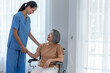 © Supakit - Young nurse taking care elderly disabled woman sitting in a wheelchair with copyspace.
