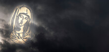 Christian Saint, The Mother Of Jesus. Worrisome Golden Figure Amongst Dark Clouds. Symbol Of Motherhood Looking At The World Concept. Copy Space For Additional Content.
