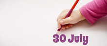 A Child's Hand Writes 30 July In A Lilac Pencil. Banner With Copy Space