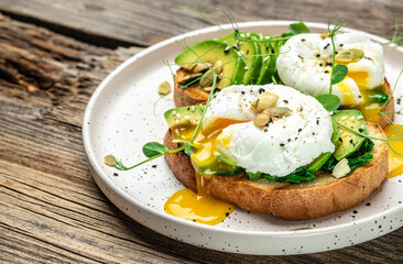 Wall Mural - Sandwich with spinach, avocado, egg and pumpkin seeds on the wooden table, Healthy food, keto diet, diet lunch concept. top view. place for text