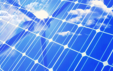 Solar panel with reflection of wind turbine and bright blue sky and cloud. Green energy or environment concept.