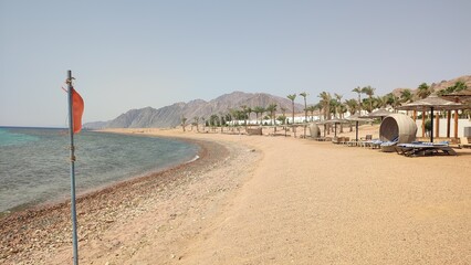 view of the beach, red flag of sea water simbol 