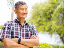 Portrait Close-up Shot Of Middle-aged Asian Male Model With Short Black Hair Wearing A Plaid Shirt With Stand Smiling At Home