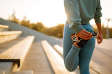 Young Woman In Sports Outfit Doing Exercises Outdoors In The Morning. Sport Woman Doing Stretching Exercise. Sport, Active Life, Sports Training, Healthy Lifestyle.