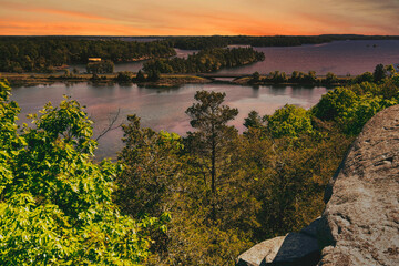 Wall Mural - Stunning scenic landscapes from the interior of Ontario Canada in the Canadian Shield.  Explore forests and beautiful pristine lakes at sunset in a beautiful foliage of nature.  