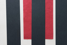 Black And Red Paper Pieces Arranged On A Gray Beige Background (stripes)