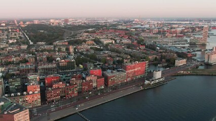 Wall Mural - Aerial Drone Shot of the Westdock Canal of Amsterdam, Netherlands on a beautiful sunrise morning with modern architecture