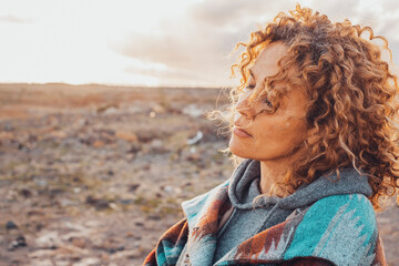 Portrait of pretty adult woman with closed eyes feeling the nature sensation and emotions. Inner balance and healthy mind lifestyle concept female people enjoying outdoors. Desert in background