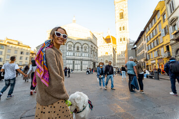 Canvas Print - Woman walking near famous Santa Maria del Fiore cathedral in Florence. Concept of visiting italian landmarks and travel Italy. Stylish woman wearing colorful shawl