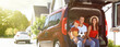 © New Africa - Happy family sitting in car trunk outdoors. Banner design