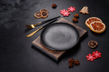 Christmas Table Setting With Empty Black Ceramic Plate, Fir Tree And Black Accessories
