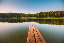 Wooden Pier On A Quiet Lake In The Morning.