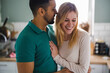 © pikselstock - Young couple in love hugging at home