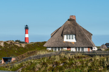 Wall Mural - Thatched roof house with lighthouse, Hörnum, Sylt, Schleswig-Holstein, Germany