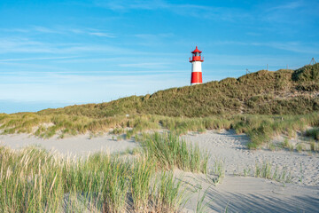 Wall Mural - red lighthouse standing near the coast of sylt, north sea, germany
