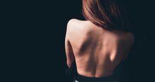Young Woman Stands With Bare Back