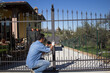 © gianni - Picture of a handyman painting the driveway gate of the house