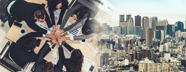 Wall Mural - Happy business people celebrate teamwork success together with joy at office table shot from top view . Young businessman and businesswoman workers express cheerful victory in broaden view .