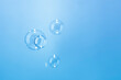 © Siwakorn1933 - Abstract Transparent Soap Bubbles Floating on Blue Background. Soap Sud Bubbles Water