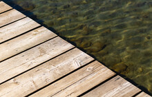 Wooden Pier Over Water. Deck On A Lake