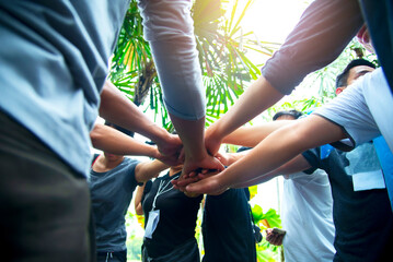 Wall Mural - Teamwork Hands of spirit team working together outdoor. Unity strong handshake with people or agreement of feeling or happy diverse education action