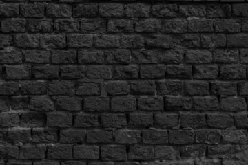  Black brick wall of the building. Designer building background.