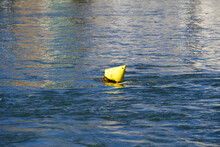 Moored Yellow Buoy Swimming On Rhine River On A Sunny Spring Day. Photo Taken May 11th, 2022, Basel, Switzerland.