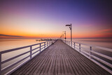 Fototapeta Pomosty - Amazing sunrise over the pier i Mechelinki. Baltic sea