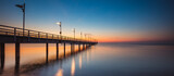 Fototapeta Dmuchawce - Amazing sunrise over the pier i Mechelinki. Baltic sea