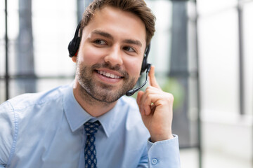 Sticker - Smiling friendly handsome young male call centre operator.