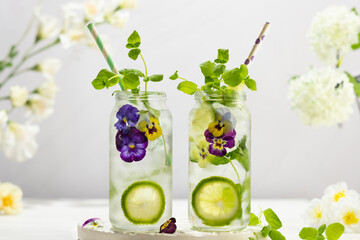 Wall Mural - Cold Infused detox water with edible flowers,lime and mint leaves. Refreshing summer drink.