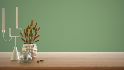 Empty interior design concept, wooden table, desk or shelf close up. Ceramic and glass vases with dry plants, straws. Green background with copy space, template mock up idea