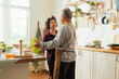 © whyframeshot - Asian senior adult couple cooking healthy food together at home while dancing in the kitchen morning weekend,happiness asian old marry couple enjoy romantic Cropped shot of a senior couple dancing