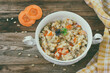 barley porridge with carrots, onions in white bowl
