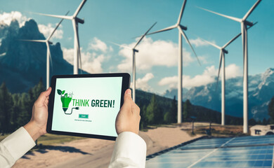 Green business transformation for environment saving and ESG business concept. Businessman using tablet to set corporate goal toward environmental friendly management and alternative clean energy use.